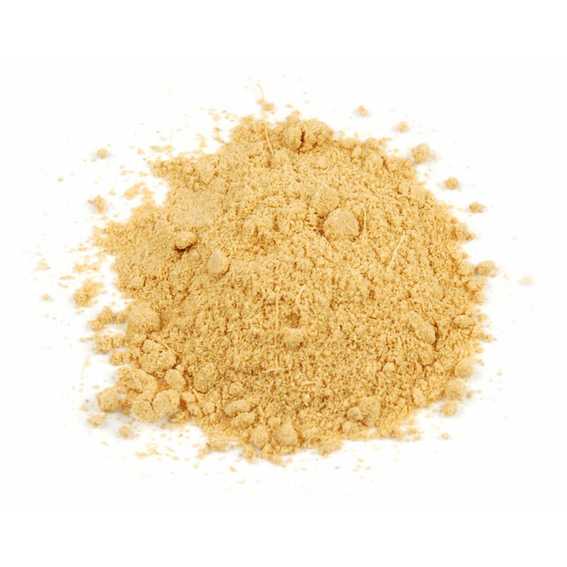 Pile of organic ground ginger root powder on a white background