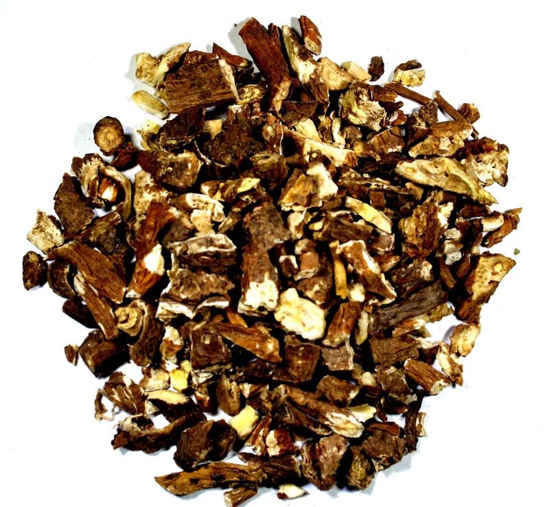 Pile of organic dried dandelion root, cut and sifted, on a white background
