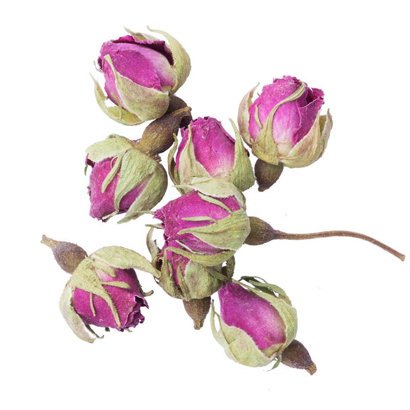 Organic whole dried pink rose buds on a white background