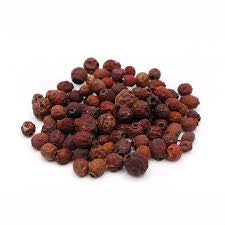 A pile of dried whole Crataegus berries, also known as hawthorn berries, against a white background.