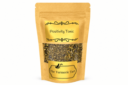 Positivity Tonic loose leaf herbal tea in a kraft pouch with a window, by The Turmeric Tart